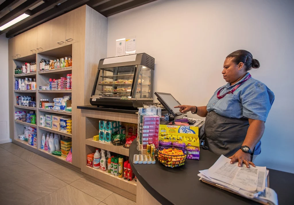 Woman working the register at Wantok Shop