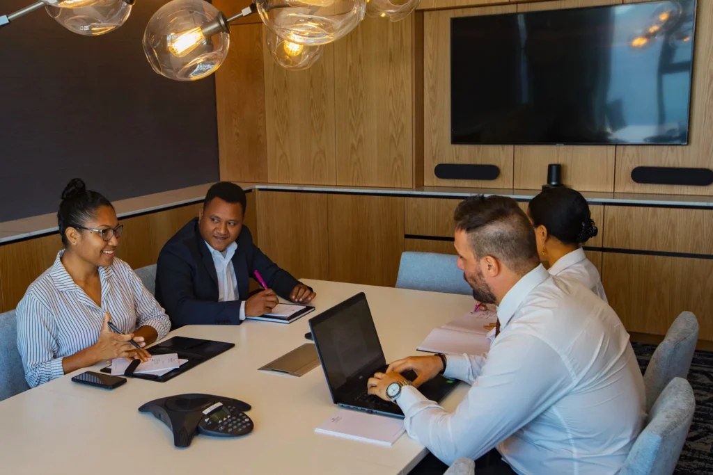 Four people sitting in a meeting room