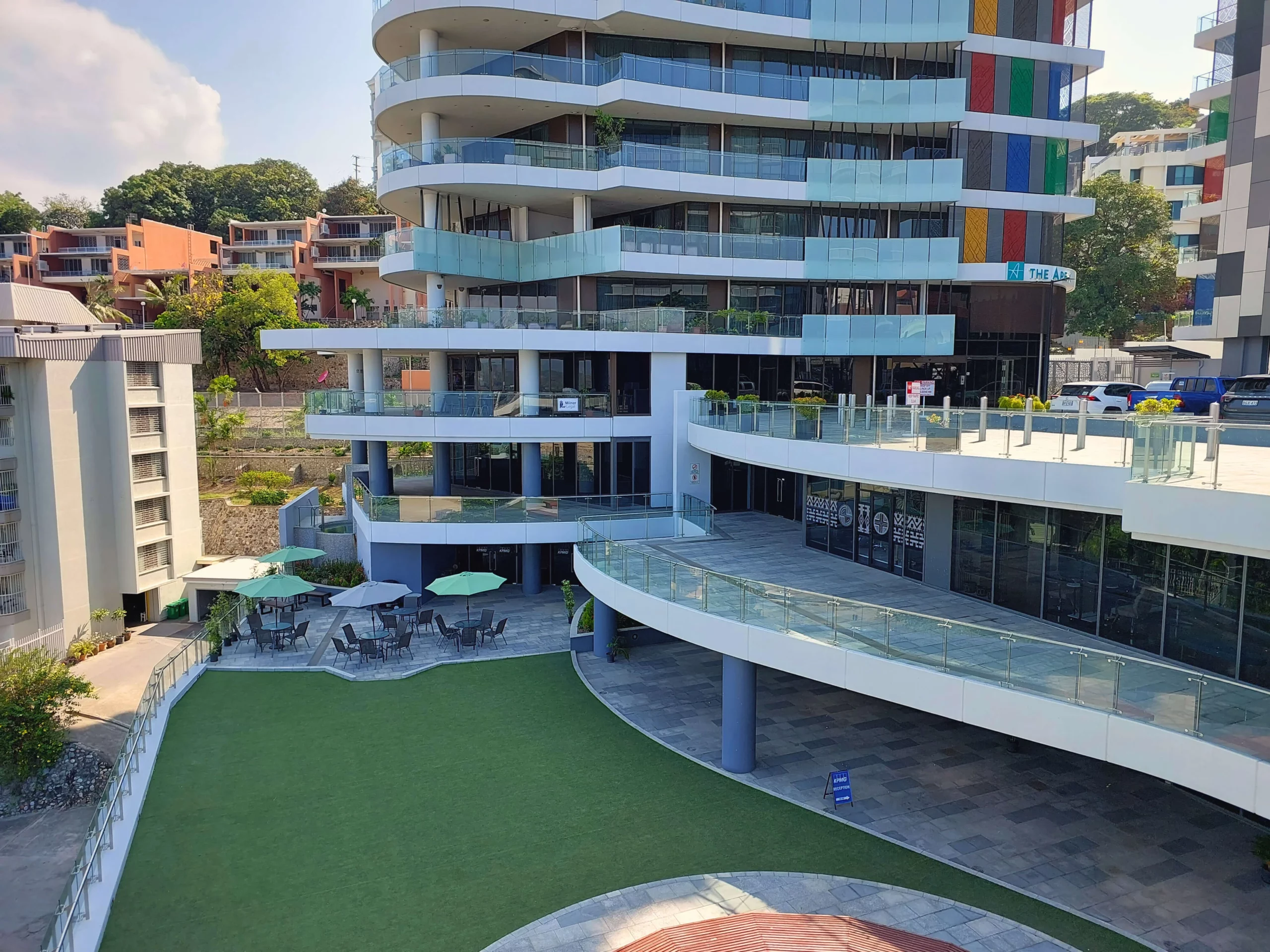 View looking down to Commercial Plaza lawn area with chairs and tables with umbrellas